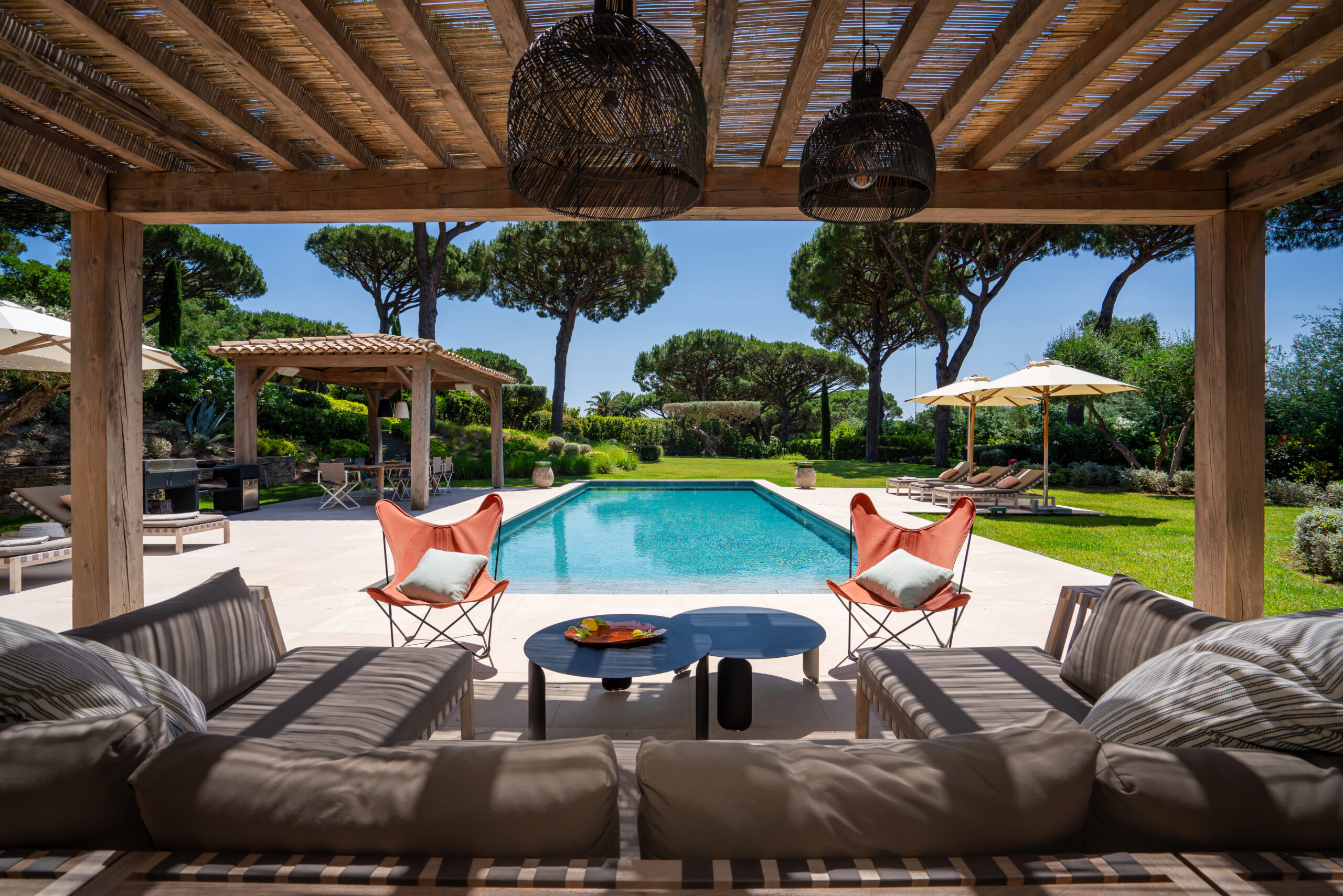 Covered terrace with lounge and pool at Villa Ellia in Saint-Tropez