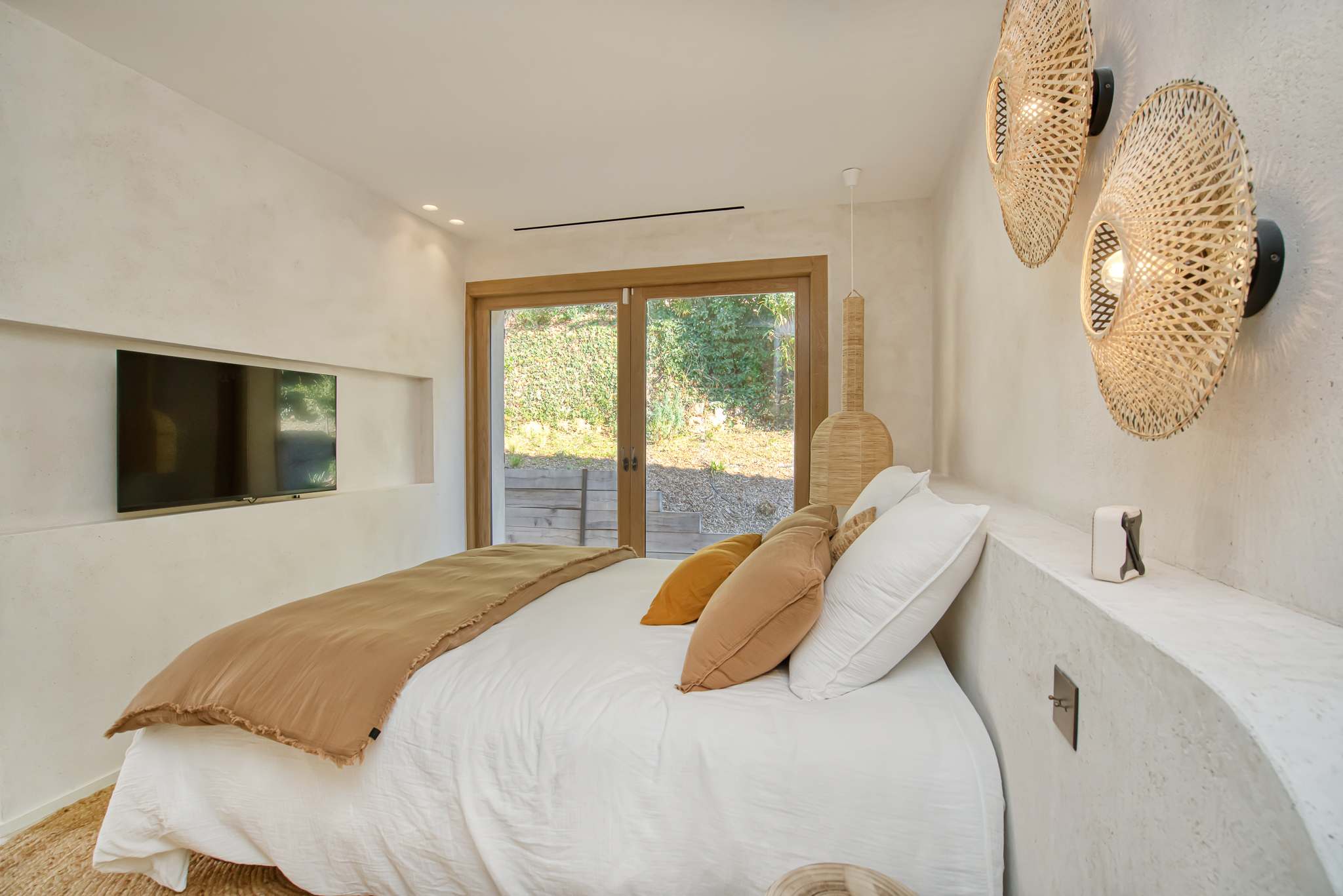 Warm bedroom in natural tones at Villa Nu in Saint-Tropez
