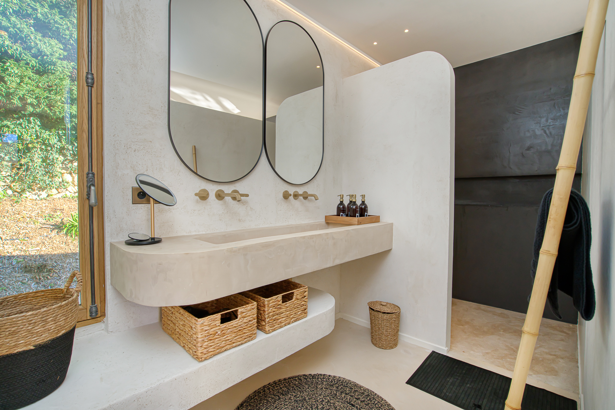 Designer bathroom with oval mirrors at Villa Nu