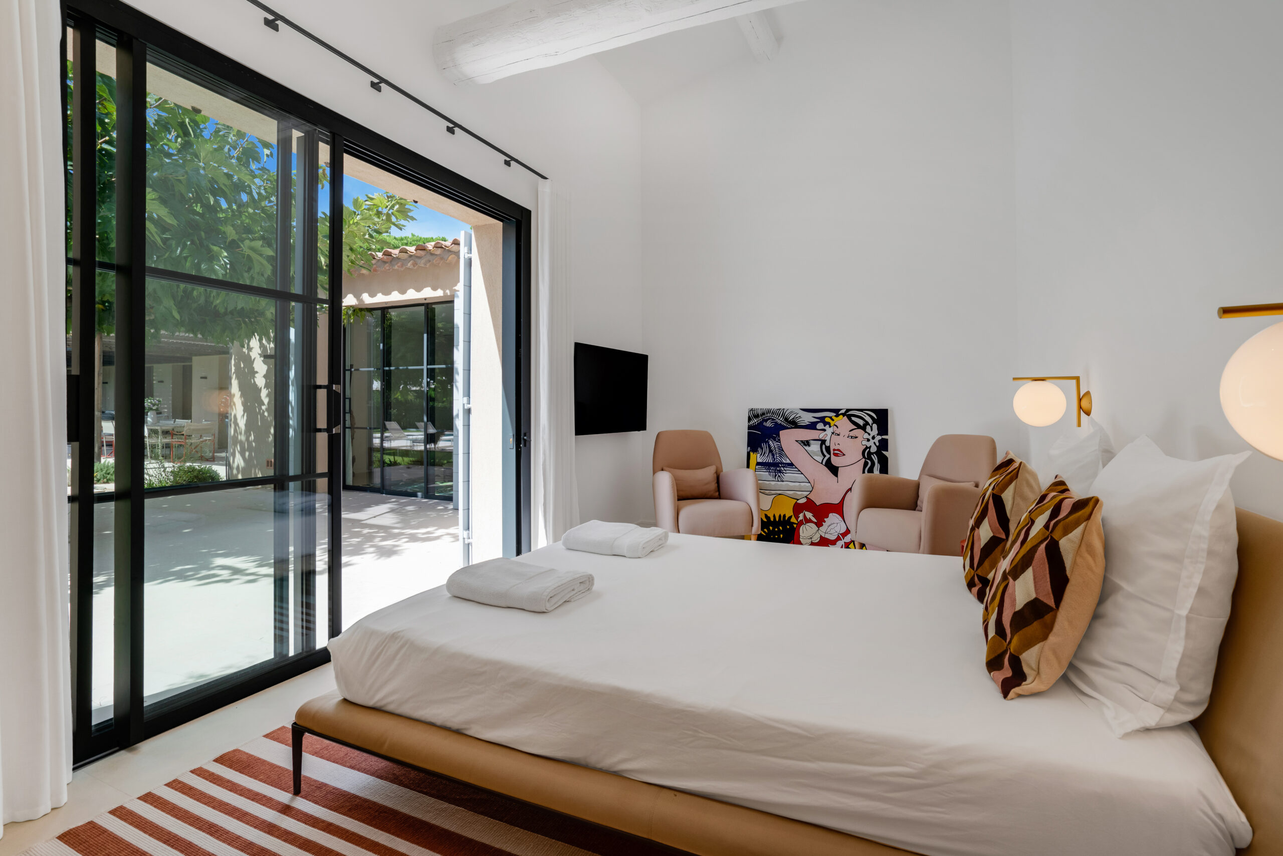 Bright bedroom opening onto the garden at Villa Charlotte in Saint-Tropez