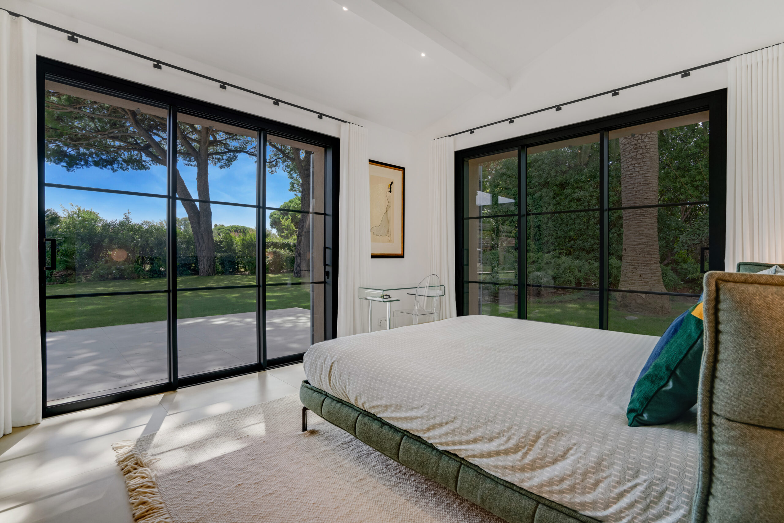 Bedroom with picture windows overlooking the pines at Villa Charlotte
