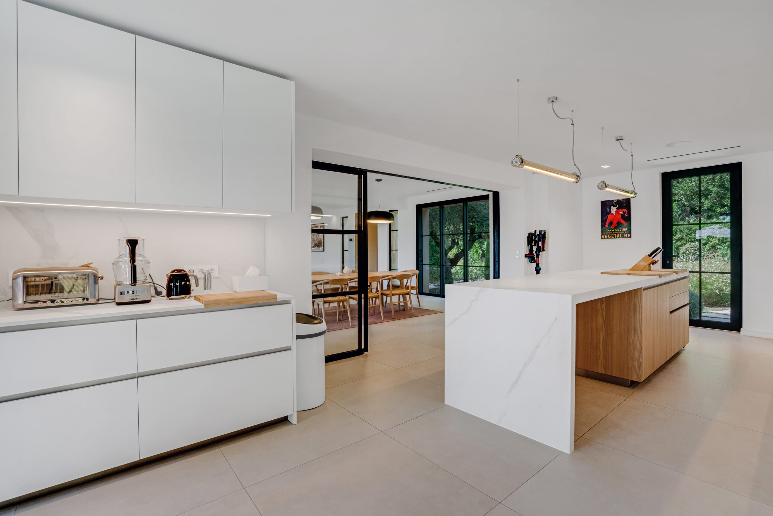 White kitchen open to the living room at Villa Charlotte