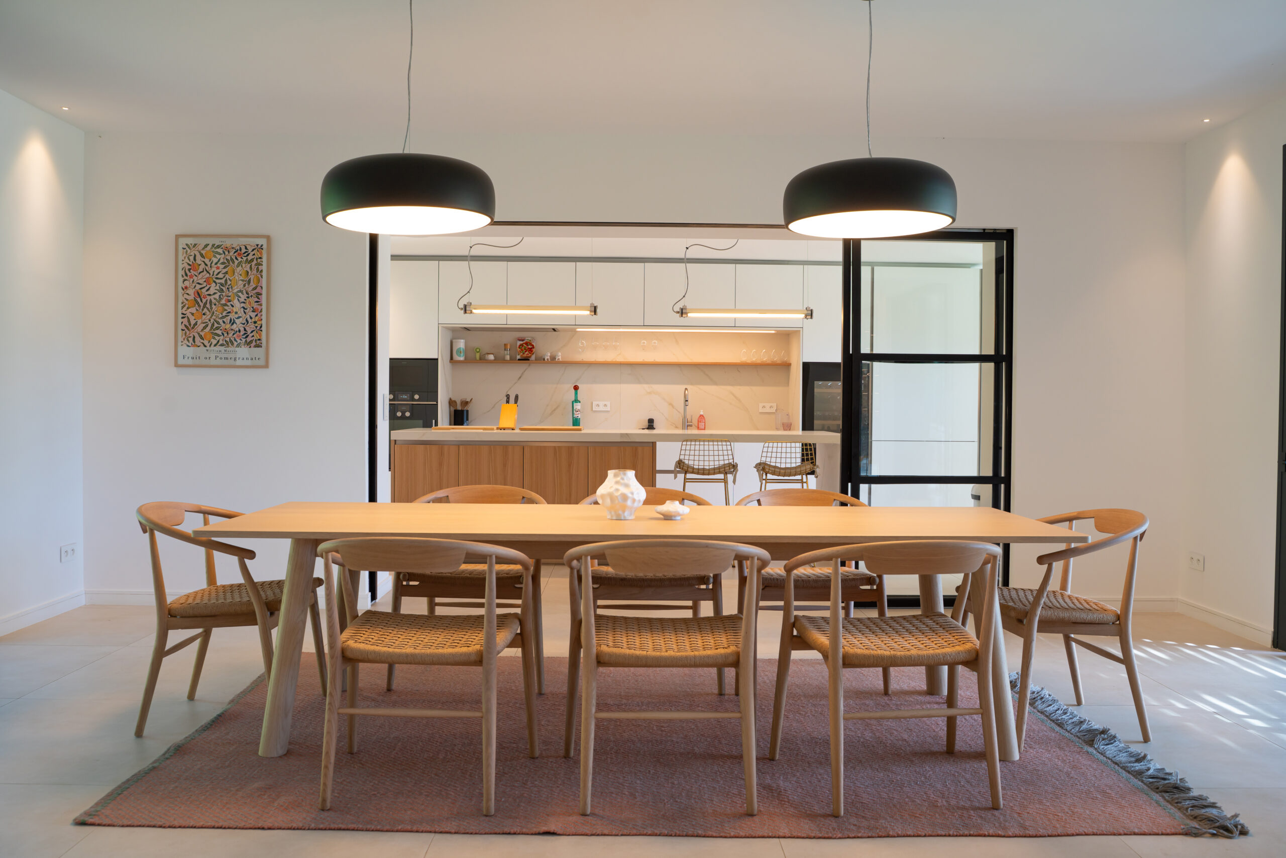 Large dining table and open kitchen at Villa Charlotte