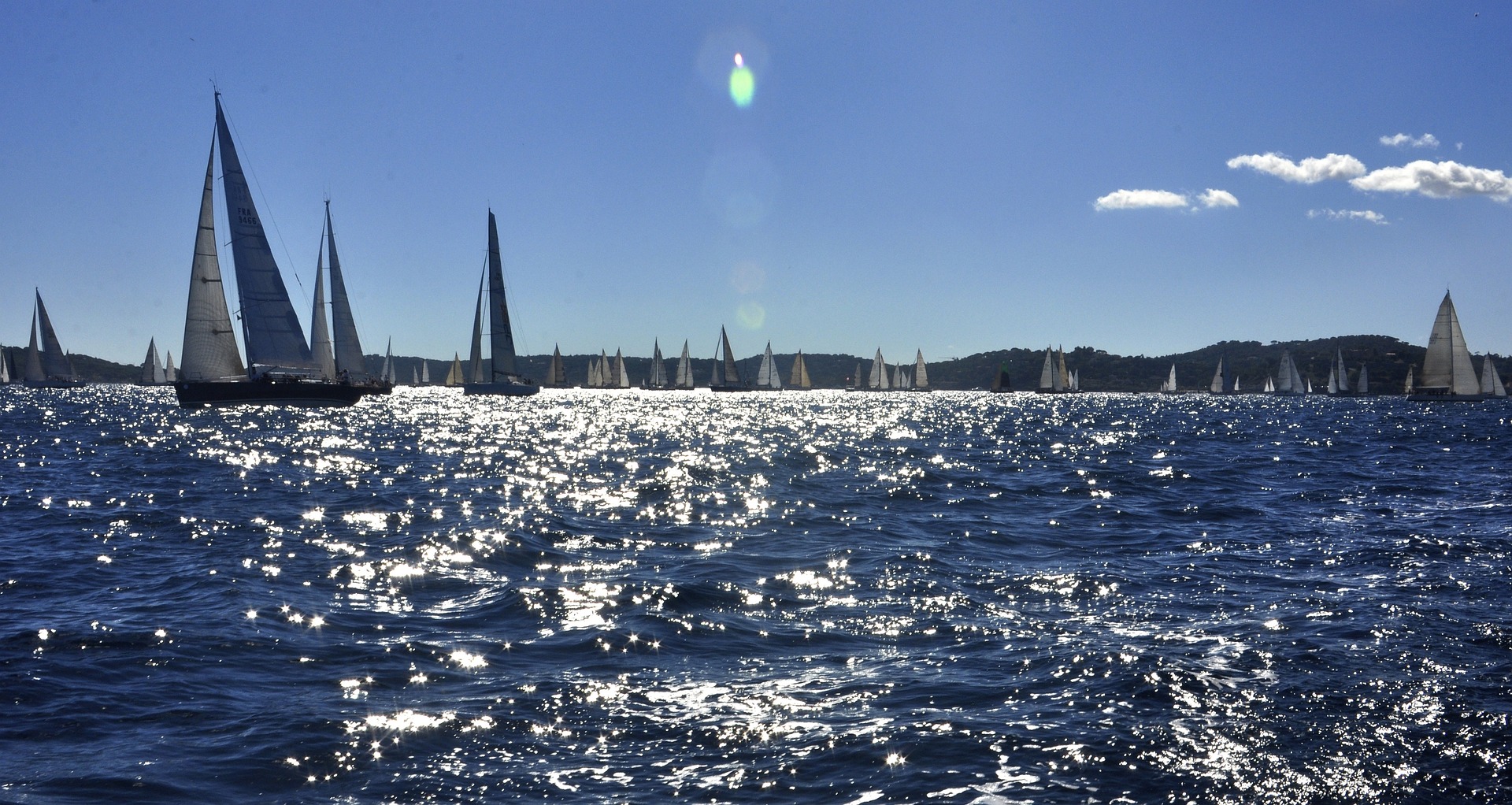 Sailing yachts racing on the sparkling sea of the Gulf of Saint-Tropez